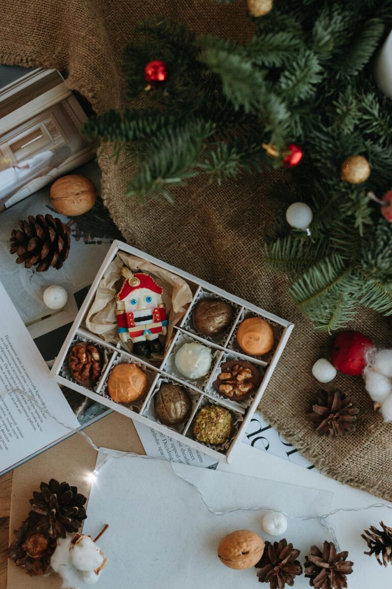Assorted Christmas chocolates under a decorated tree, perfect for holiday gifting.