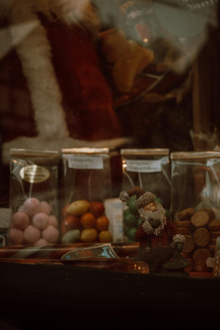 Colorful candy display with Santa figurine in Monschau during winter.