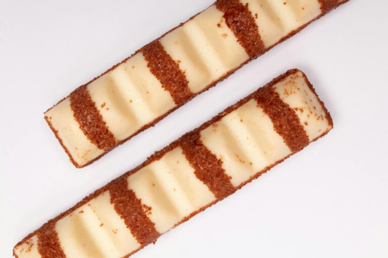 Top view of two chocolate and cream wafer bars on a white background.